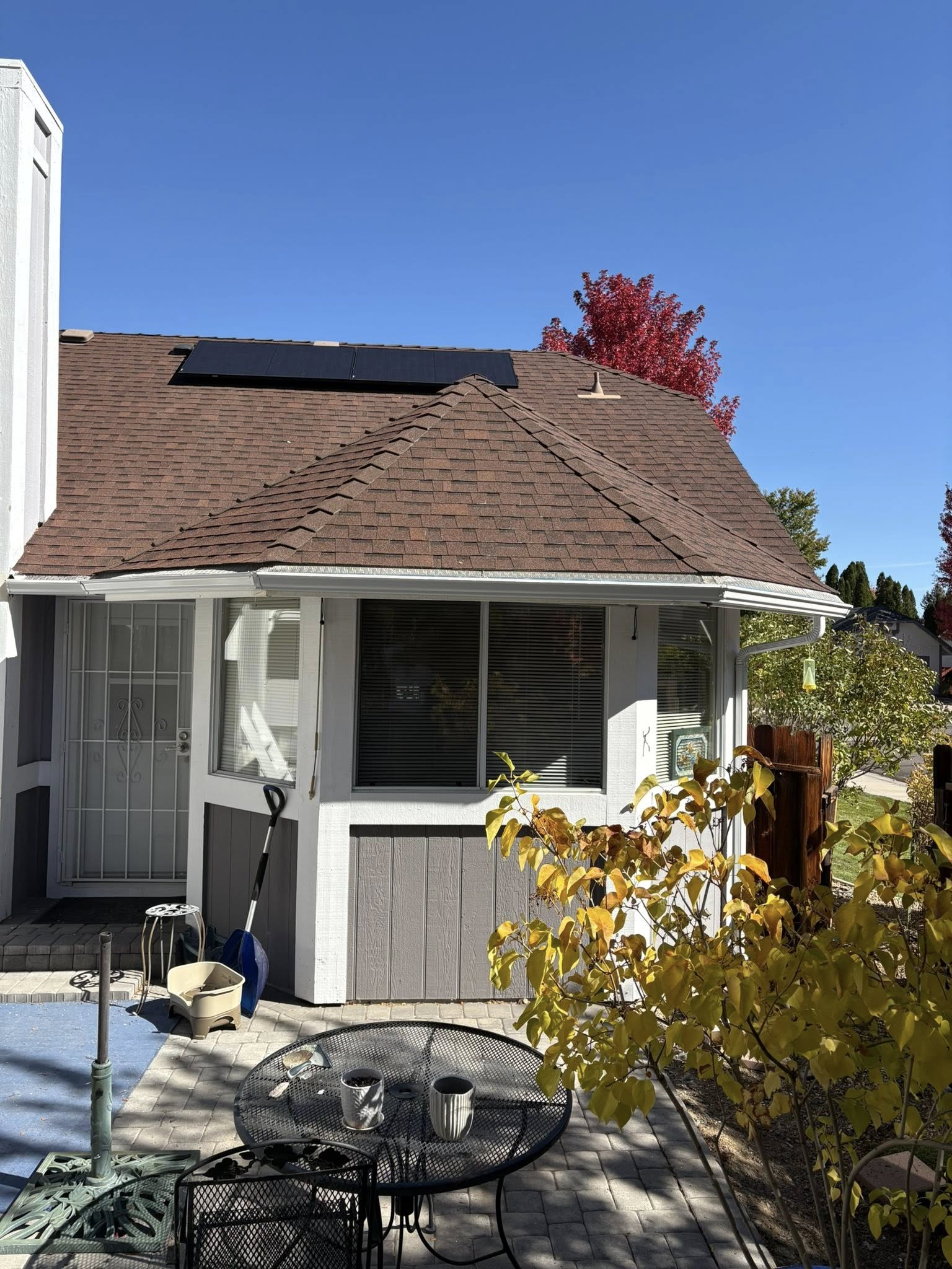 House with solar panels and autumn foliage